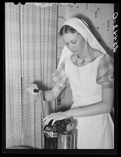 A demonstration of canning with a pressure cooker before a district meeting of FSA (Farm Security Administration) supervisors