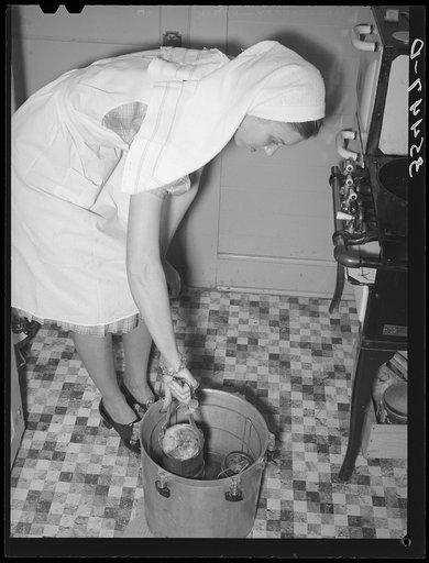 FSA (Farm Security Administration) supervisor giving a demonstration of pressure canning before a group of FSA officials at a district meeting. San Angelo, Texas. She is removing cans from pressure cooker