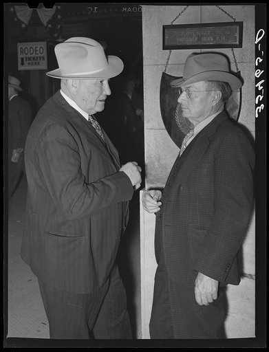 Cattlemen talking in the hotel lobby during the San Angelo Fat Stock Show. San Angelo, Texas