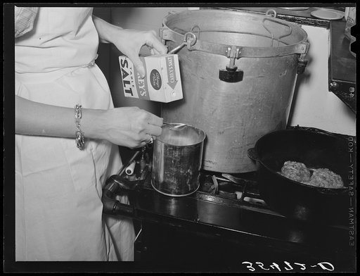 Putting salt in a can in which meat will be canned using the pressure cooker method. This was during the demonstration by a FSA (Farm Security Administration) supervisor at a district meeting of FSA officials. San Angelo, Texas
