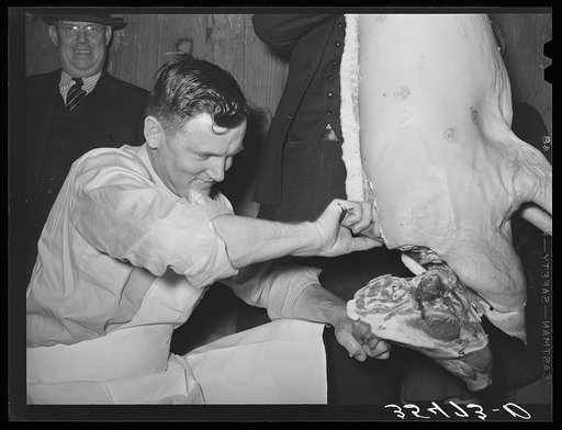 FSA (Farm Security Administration) supervisor giving a demonstration of meat cutting before a group of FSA officials at a district meeting. San Angelo, Texas