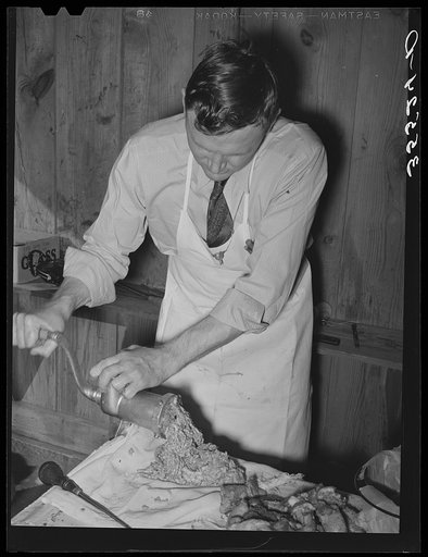 FSA (Farm Security Administration) supervisor making sausage during a meat cutting demonstration before FSA officials and supervisors at a district meeting at San Angelo, Texas