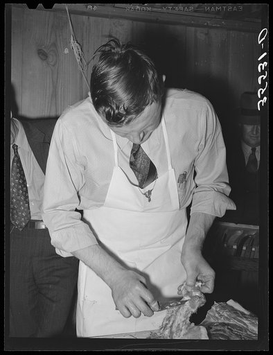 Untitled photo, possibly related to: FSA (Farm Security Administration) supervisor sewing up a pork rolled roast during a meat cutting demonstration before a group of FSA supervisors and officials at a district meeting in San Angelo, Texas