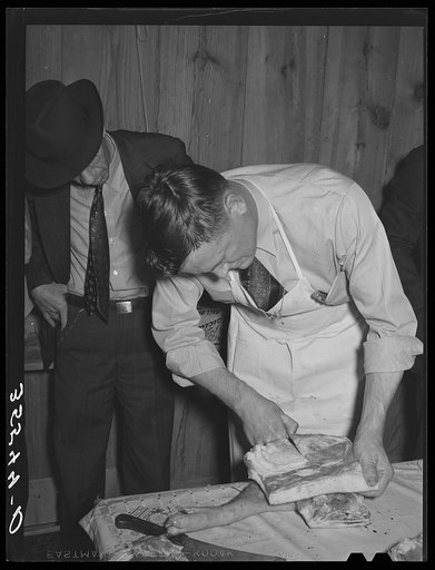 FSA (Farm Security Administration) supervisor slicing bacon during meat cutting demonstration before FSA officials and supervisors at a district meeting. San Angelo, Texas