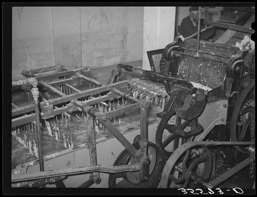 Part of wool scouring machine. The metal forks pull the wool through the hot alkaline solution. Wool scouring plant, San Marcos, Texas