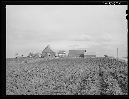 Plowed land in front of farmhouse in Travis County, Texas