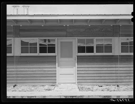 Entrance to a unit in the row shelters for migratory workers at the migratory labor camp. Sinton, Texas
