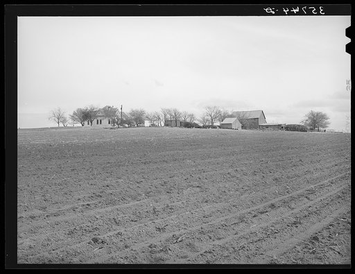 Plowed land in front of farmstead in Williamson County, Texas