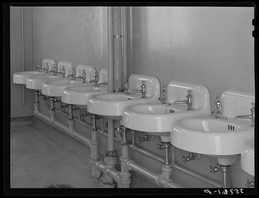 Wash basins in one of the sanitary units at the migratory labor camp, Sinton, Texas. These pictures were taken before the camp had been occupied