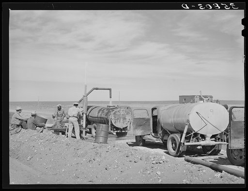 Filling tanks with water to be used in road construction. Gaines County, Texas