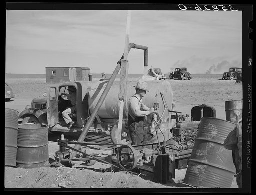 Filling tank with water to be used in road construction. Gaines County, Texas