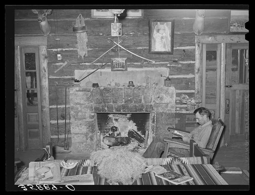 Proprietor of the Navajo Lodge before the fireplace. Datil, New Mexico