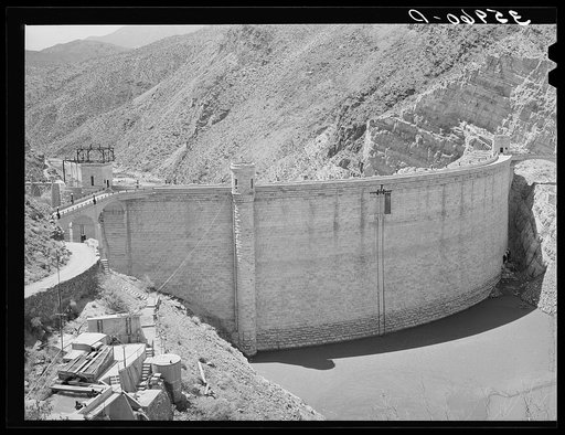 Roosevelt Dam showing small amount of impounded water because of extended drought. This is the main source of water for irrigation in the Salt River Valley. Gila County, Arizona
