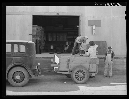 Farmer loading cut lumber from warehouse of the United Producers and Consumers Cooperative. Phoenix, Arizona