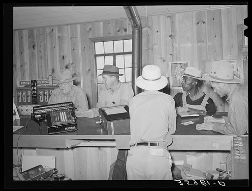 Members of the United Producers and Consumers Cooperative in one of the offices of the association. This cooperative is open to all races. Phoenix, Arizona