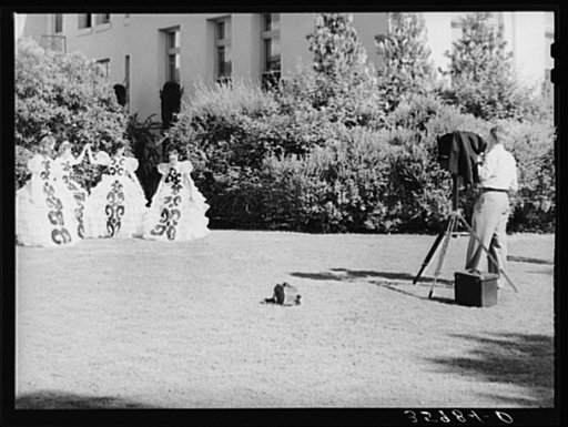 Young high school girls being photographed in their graduation play costumes. Phoenix, Arizona