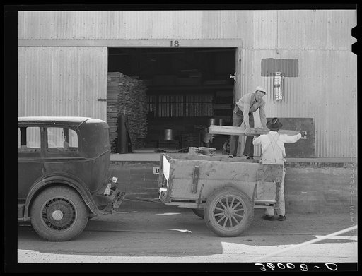 Farmer loading lumber onto his truck at the United Producers and Consumers Cooperative. Phoenix, Arizona