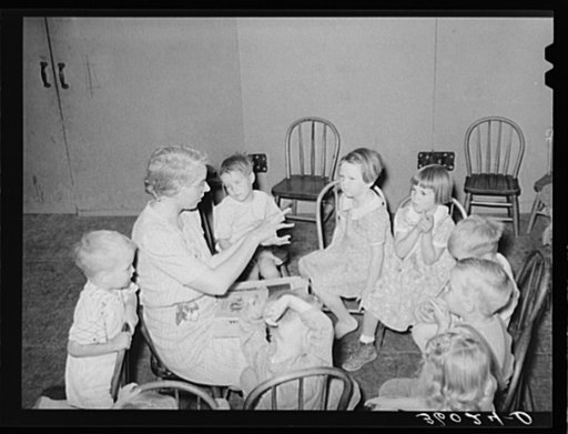WPA (Work Projects Administration) nursery teacher telling story to children of agricultural workers living at the Agua Fria migratory labor camp. Arizona