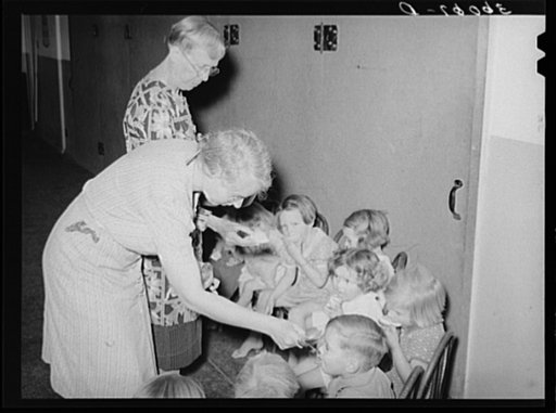 Children receiving cod liver oil and grapefruit at the WPA (Work Projects Administration) nursery school at the Agua Fria migratory labor camp. Arizona