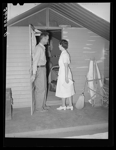 Nurse making a call at one of the individual metal shelters at the Agua Fria migratory labor camp. Arizona
