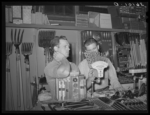 Member of the United Producers and Consumers Cooperative selecting a drill. Phoenix, Arizona
