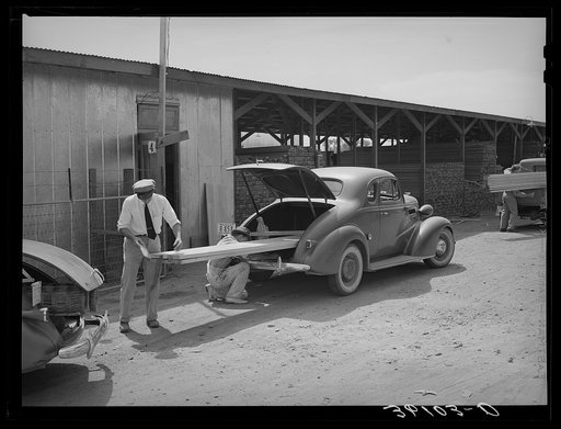 Member of the United Producers and Consumers Cooperative loading lumber into his car. Phoenix, Arizona