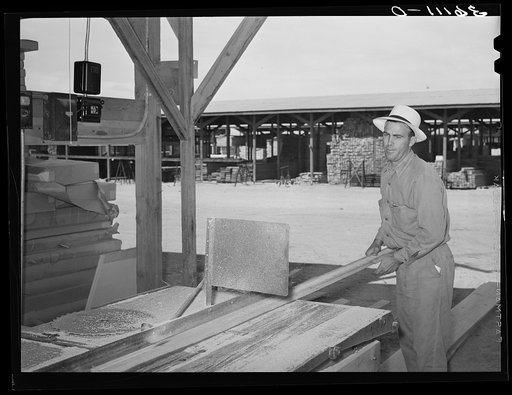 Lumber is sawed to size and order at the United Producers and Consumer Cooperative at Phoenix, Arizona