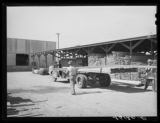 Untitled photo, possibly related to: Lumber being loaded onto truck at the Producers and Consumers Cooperative. Phoenix, Arizona