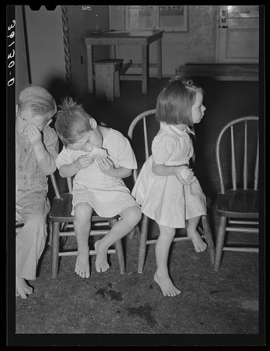 Children eating grapefruit after taking cod liver oil at the WPA (Work Projects Administration) nursery school at Agua Fria migratory labor camp. Arizona