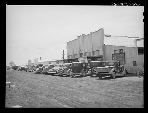 Farmers' cars in front of store and warehouse of the United Producers and Consumers Cooperative. Phoenix, Arizona