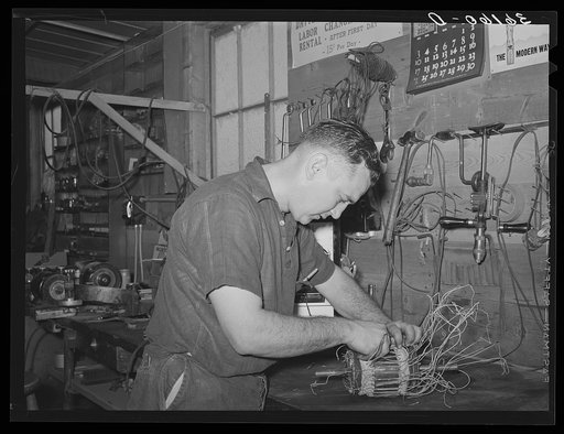 Member of the service department of the United Producers and Consumers Cooperative winding an armature. He was sent by the cooperative to Chicago to learn his trade