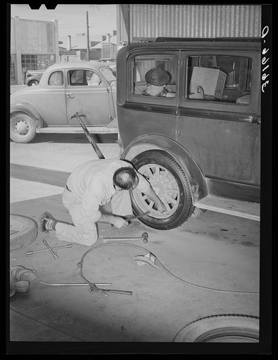 Changing a tire at the United Producers and Consumers Cooperative service station. Phoenix, Arizona