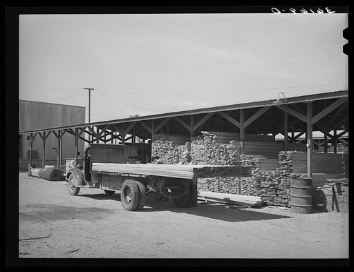 Untitled photo, possibly related to: Lumber being loaded onto truck at the Producers and Consumers Cooperative. Phoenix, Arizona