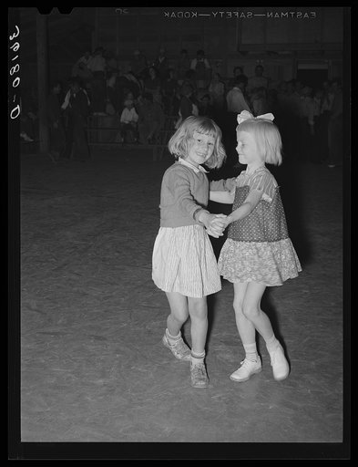 Two children of migrant agricultural workers dancing at the Saturday night dance at the Agua Fria migrant labor camp. Arizona