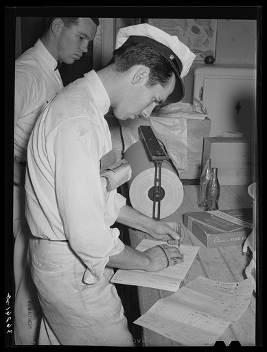 Salesman delivery man who calls at the grocery store of the Casa Grande Valley Farms. Pinal County, Arizona