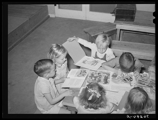 Children looking at picture books at the WPA (Work Projects Administration) nursery school at the Casa Grande Valley Farms. Pinal County, Arizona