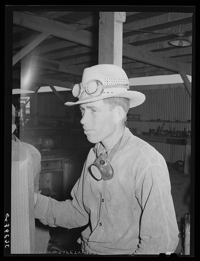 Men who work on the hay chopping machine wear goggles and masks. Casa Grande Valley Farms, Pinal County, Arizona