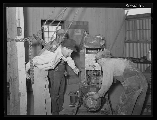 Members and FSA (Farm Security Administration) officials at Casa Grande Farms making repairs in farm machinery. Pinal County, Arizona