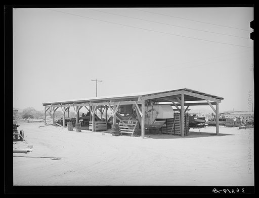 Shelter for farm machinery at the Casa Grande Valley Farms. Pinal County, Arizona
