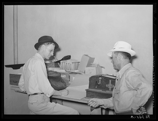 Assistant manager of the Casa Grande Valley Farms, Pinal County, Arizona, discussing a report with a member of the cooperative