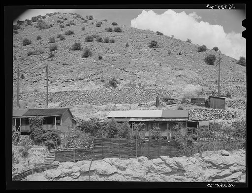 House on side of mountain in Bisbee, Arizona, showing the timber supports needed to keep soil from washing completely away from the house