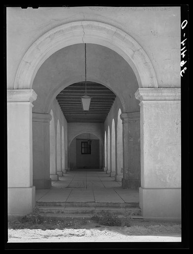 Arcade of one of the main building of the Burro Mountain Copper Company at Tyrone, New Mexico. This company constructed the elaborate office and town buildings in addition to extensive company housing. All of these are now vacant after the abandonment of the mine and the company is trying to bring t