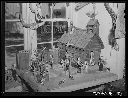 Little red schoolhouse modeled from schoolday memories of Homer Tate. Safford, Arizona. Mr. Tate is a self-trained artist working in papier mache and such indigenous materials as cactus, bone, wood and stone