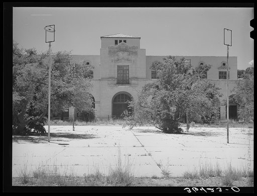 One of the main buildings with town square in foreground of the Burro Mountain Copper Company, now inactive, at Tyrone, New Mexico