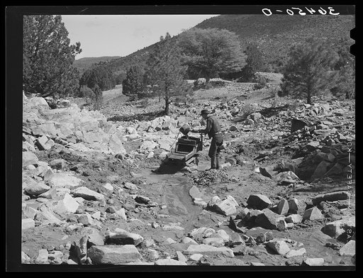 View of Eugene Davis and his creek bed working in gold placer mining. Pinos Altos, New Mexico
