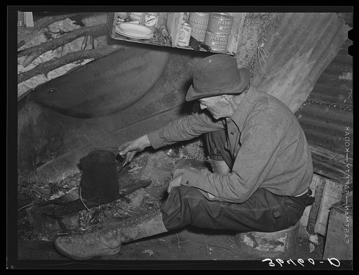 Eugene Davis, gold prospector, making a pot of coffee in his shack on his diggings at Pinos Altos, New Mexico