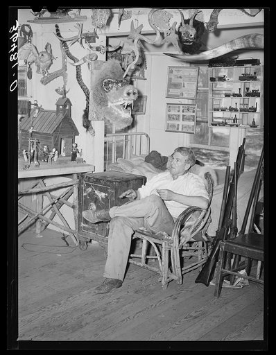 Homer Tate sitting among his creations. Safford, Arizona