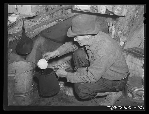 Untitled photo, possibly related to: Eugene Davis, gold prospector, making a pot of coffee in his shack on his diggings at Pinos Altos, New Mexico