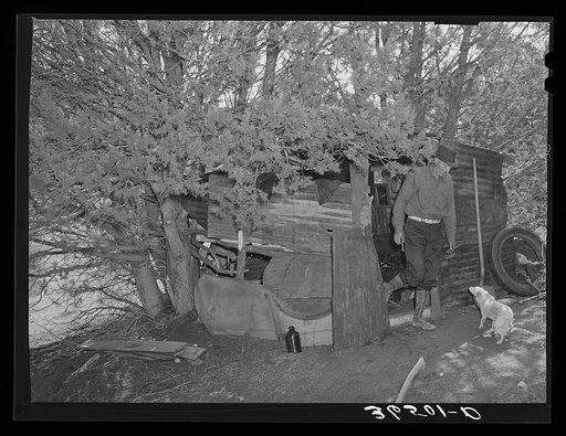Untitled photo, possibly related to: Eugene Davis, gold prospector, coming out of his shack home at his diggings at Pinos Altos, New Mexico