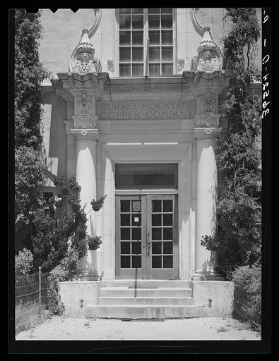 Untitled photo, possibly related to: Entrance to offices of Burro Mountain Copper Company. Tyrone, New Mexico. This copper company is no longer actively engaged in mining in this section but is attempting to make the town with its company housing into a summer resort